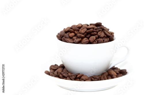 white cup with coffee beans