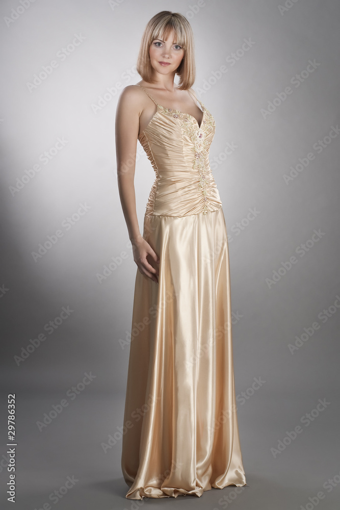 confident young woman wearing evening gown