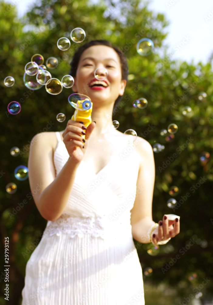 portrait of young woman blowing soap bubbles portrait of young woman blowing soap bubbles