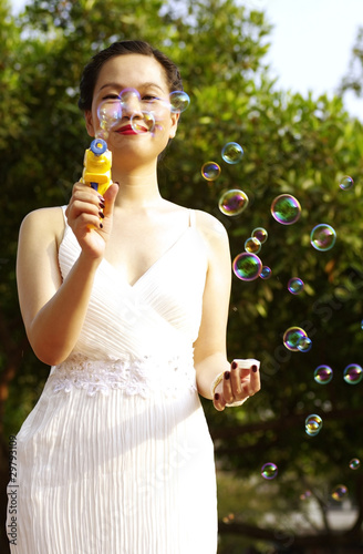 portrait of young woman blowing soap bubbles