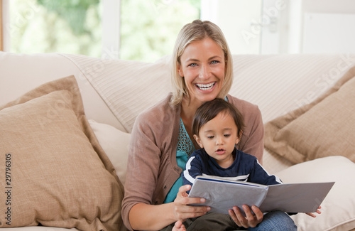 Mother looking at a book with her son