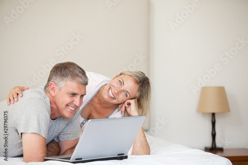 Lovely couple looking at their laptop