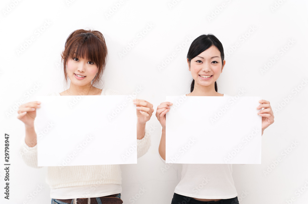 two beautiful asian women taking blank whiteboard two beautiful asian women taking blank whiteboard