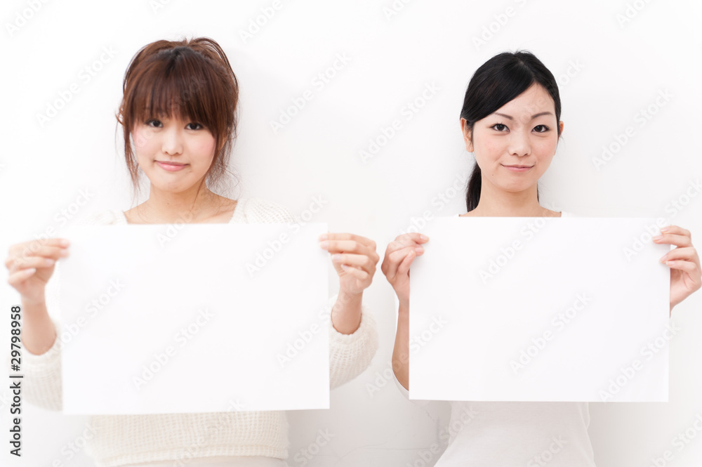 two beautiful asian women taking blank whiteboard two beautiful asian women taking blank whiteboard