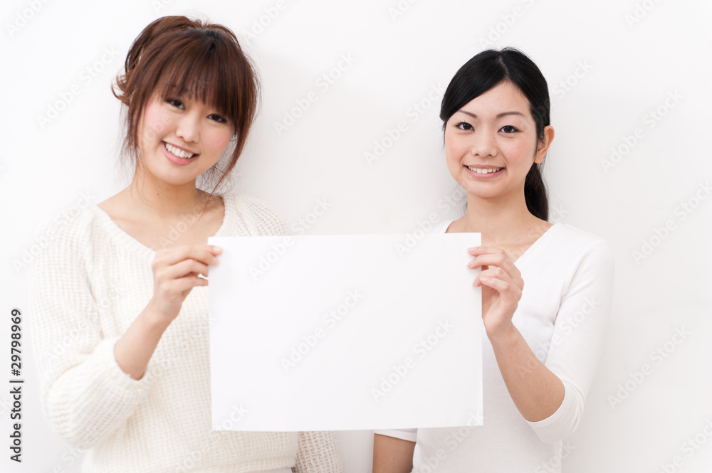 two beautiful asian women taking blank whiteboard two beautiful asian women taking blank whiteboard