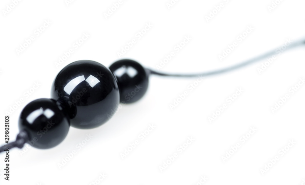 Three black balls from a beads on a white background Three black balls from a beads on a white background