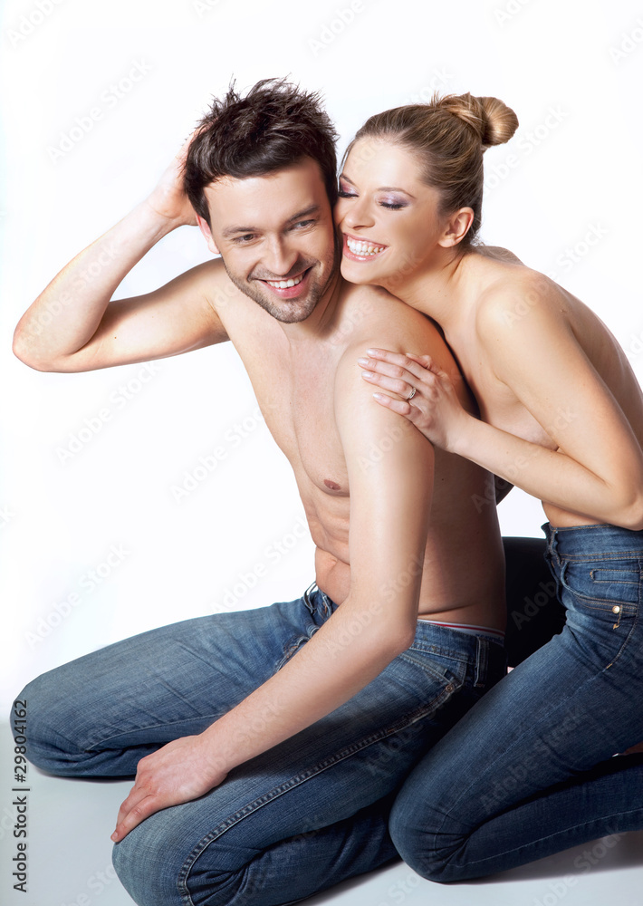 Happy young couple in casual clothing, white background Happy young couple in casual clothing, white background