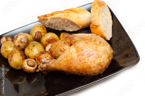 baked chicken, bread and potatoes with mushrooms
