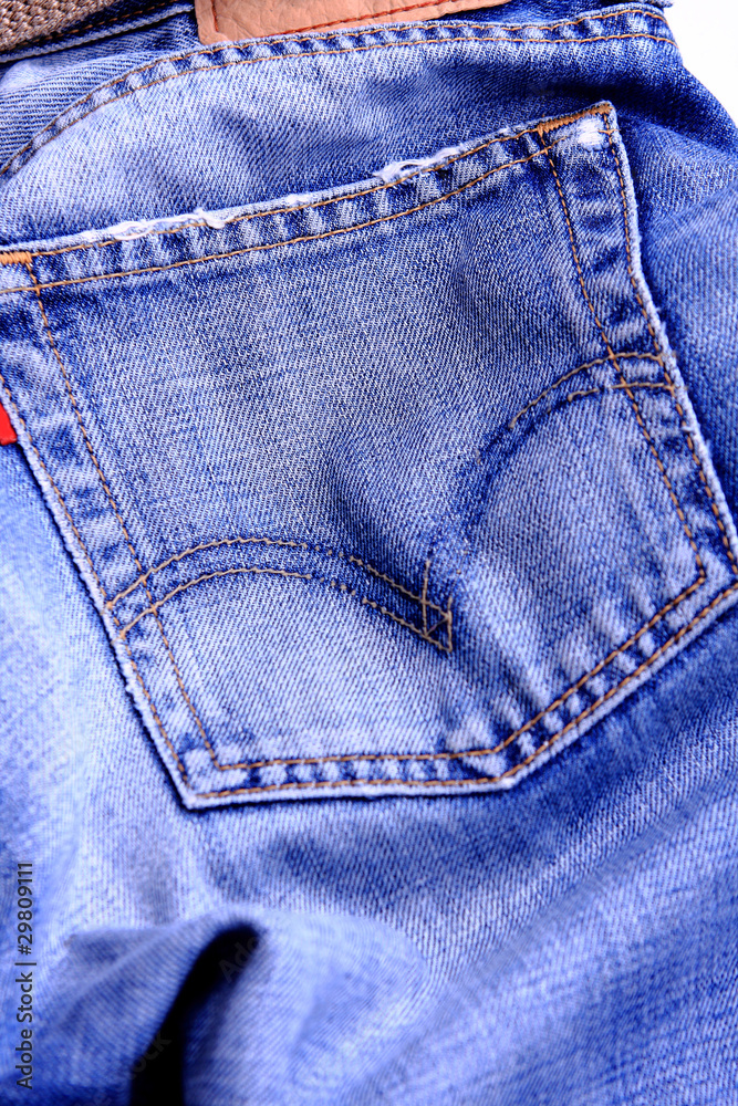 Fragment of blue modern jeans with pocket, can be used as a back Fragment of blue modern jeans with pocket, can be used as a back
