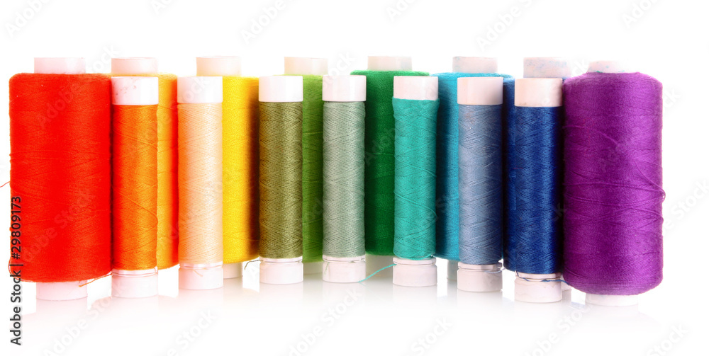 Semicircle of many-coloured bobbins of thread isolated on white Semicircle of many-coloured bobbins of thread isolated on white