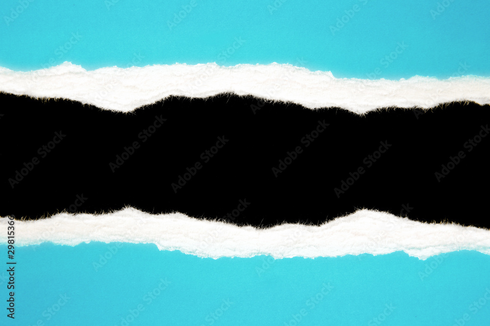 Ripped blue paper on black background. Copy space Ripped blue paper on black background. Copy space
