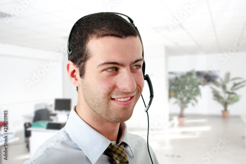 Young man wearing a headset at the office