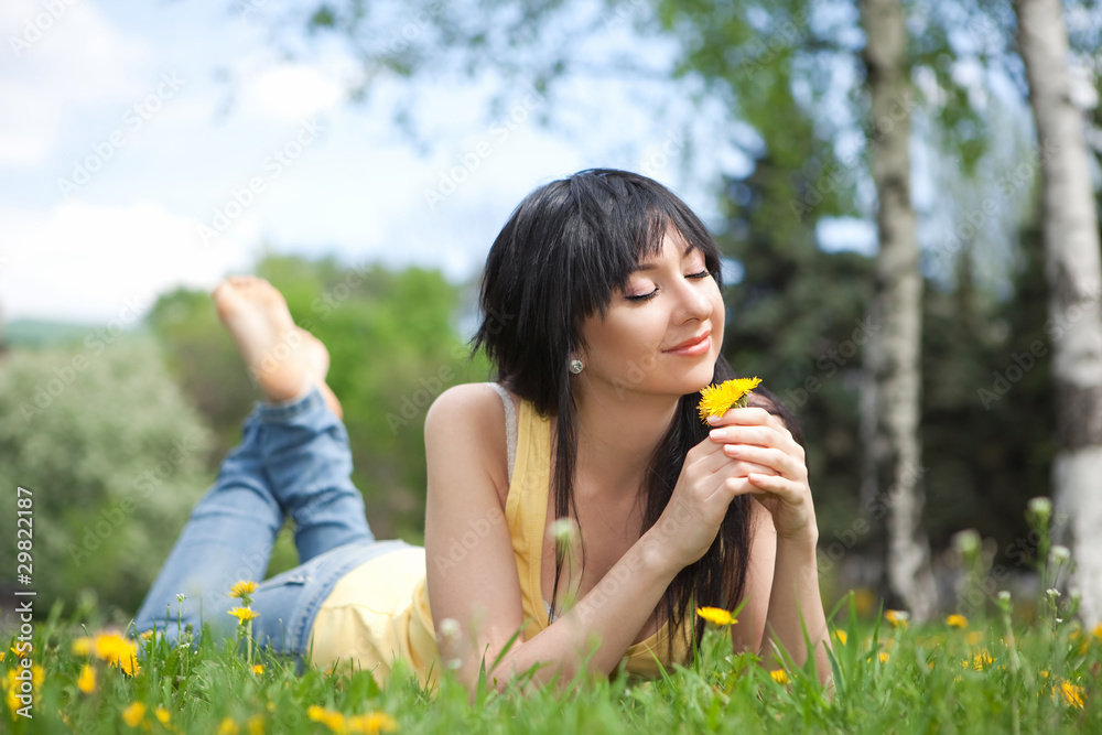 Cute woman in the park with dandelions Cute woman in the park with dandelions