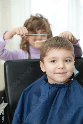 little funny children play in the barbershop