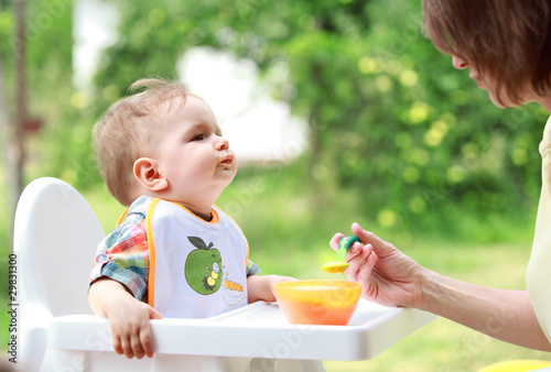 Mother feed her lovely baby photo