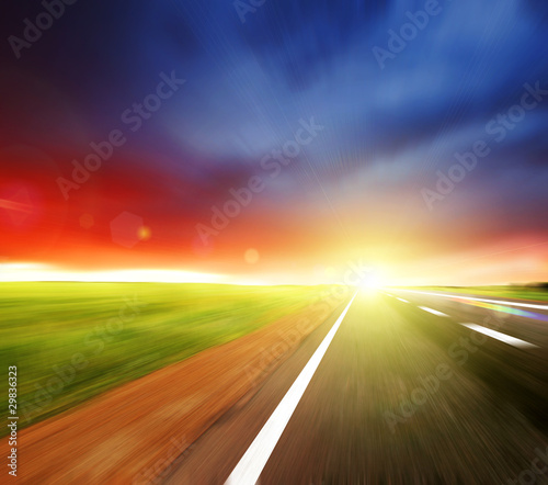 Blurred Road with blurred sky with sun