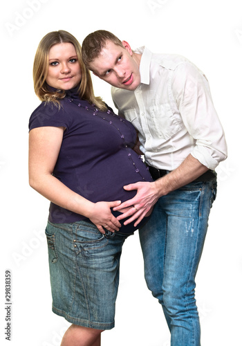 Pregnant woman with her husband isolated on white