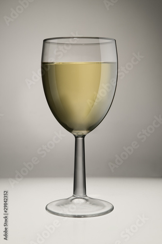 Glass Of White Wine On White Background In Studio
