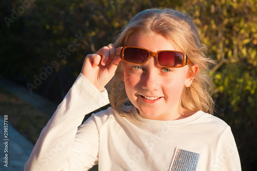 smiling teen girl wearing suglasses outdoor