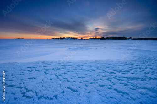 Vászonkép Sunset and icy snow.