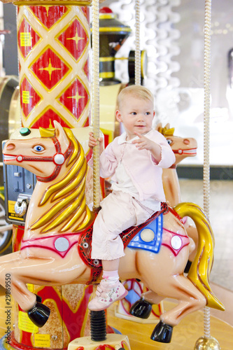 sitting toddler on carousel photo