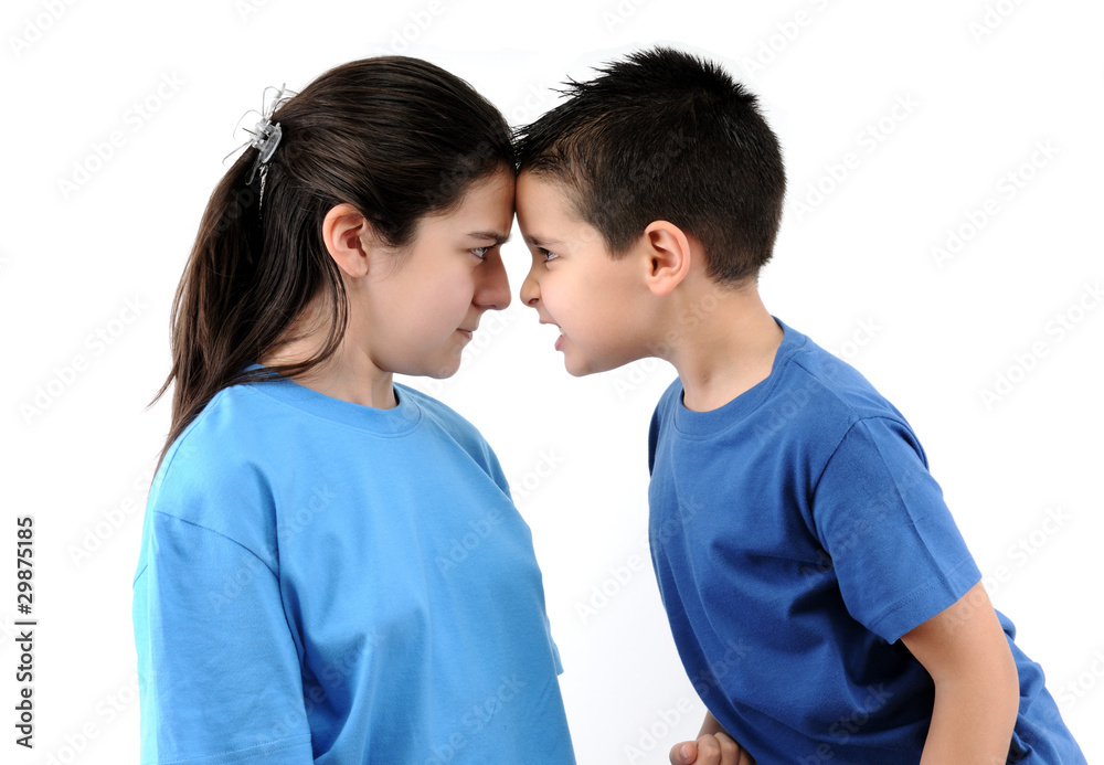 Cute boy and teen girl shouting each other head to head. Cute boy and teen girl shouting each other head to head.