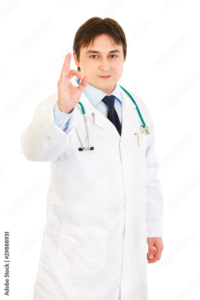 Smiling medical doctor showing ok gesture Smiling medical doctor showing ok gesture