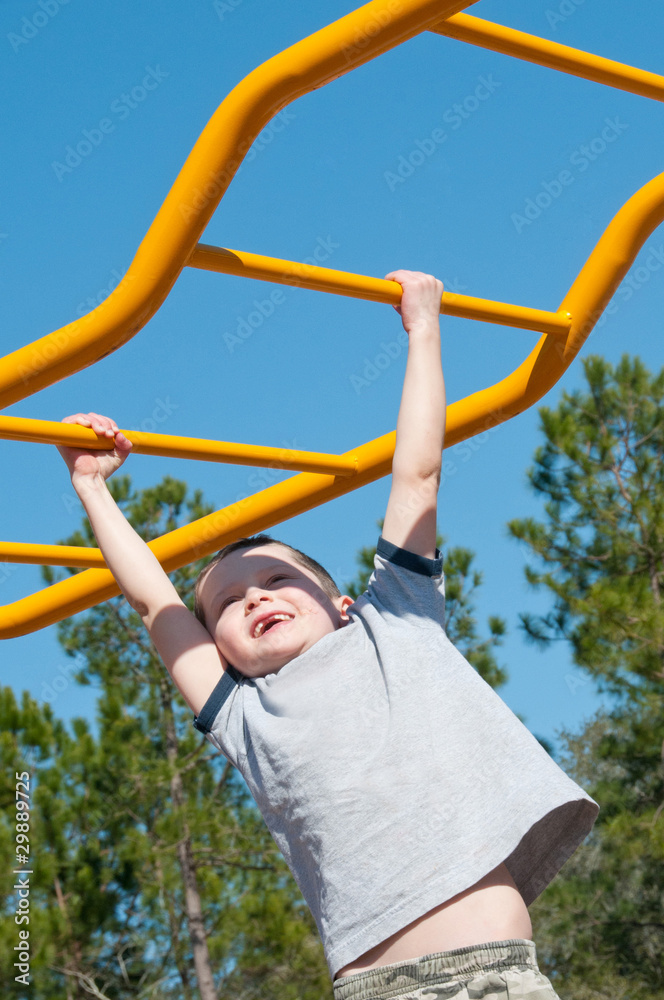 boy on monkey bars boy on monkey bars