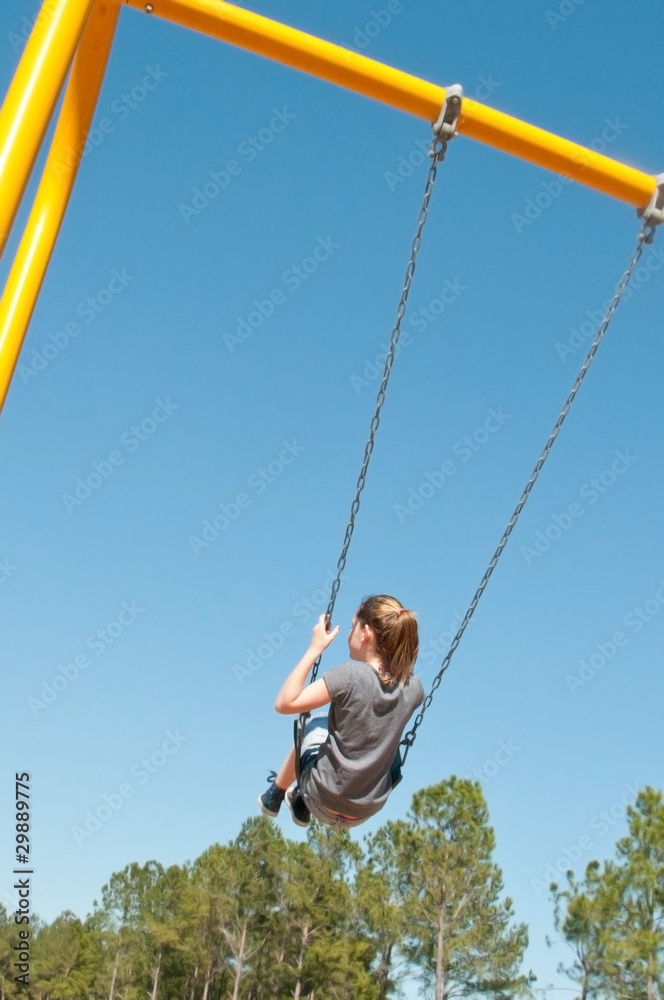 child swinging in the park