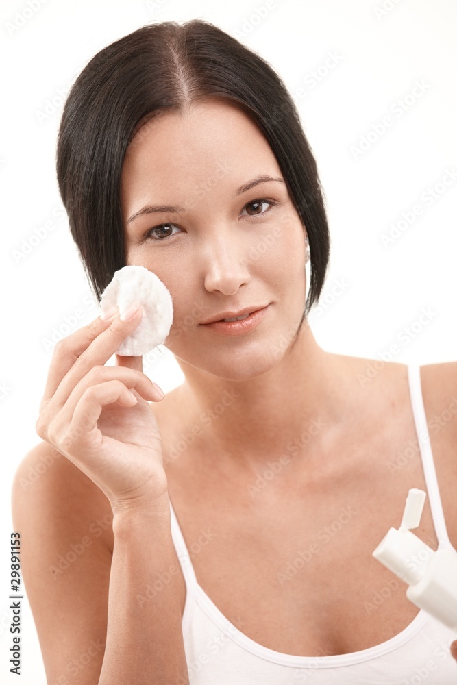 Beautiful young woman cleaning face Beautiful young woman cleaning face