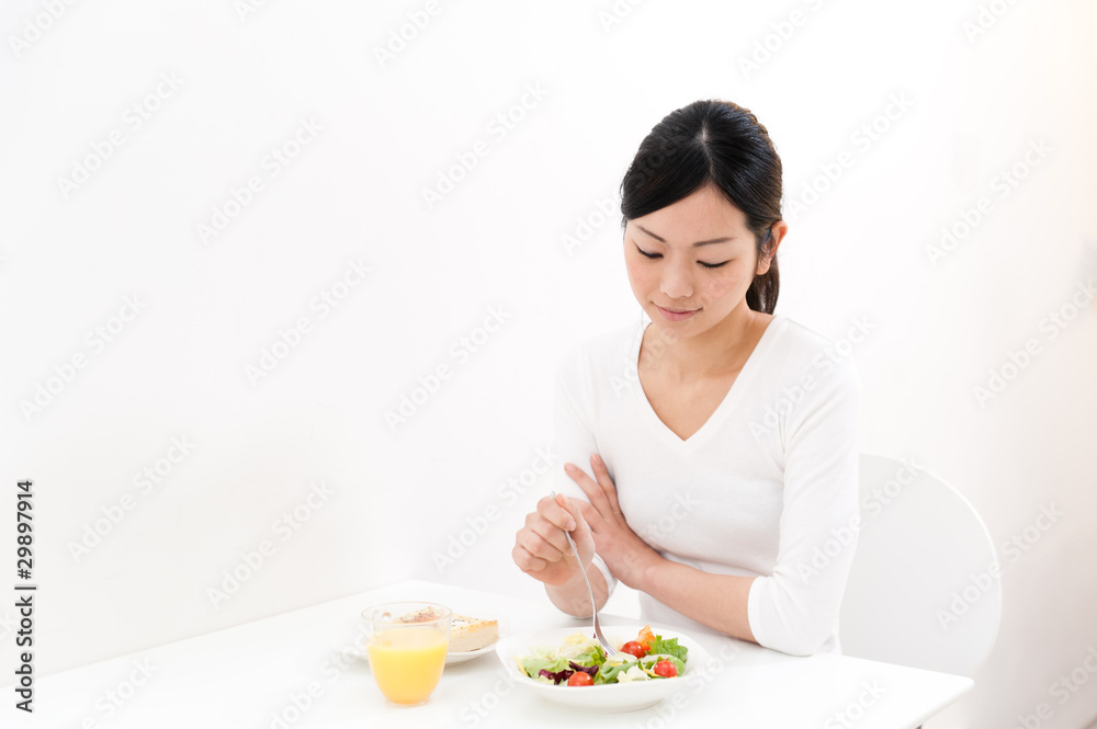 beautiful asian woman eating breakfast