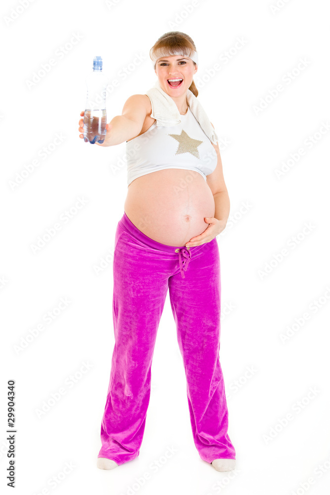 Happy pregnant woman in sportswear holding bottle of water. Happy pregnant woman in sportswear holding bottle of water.