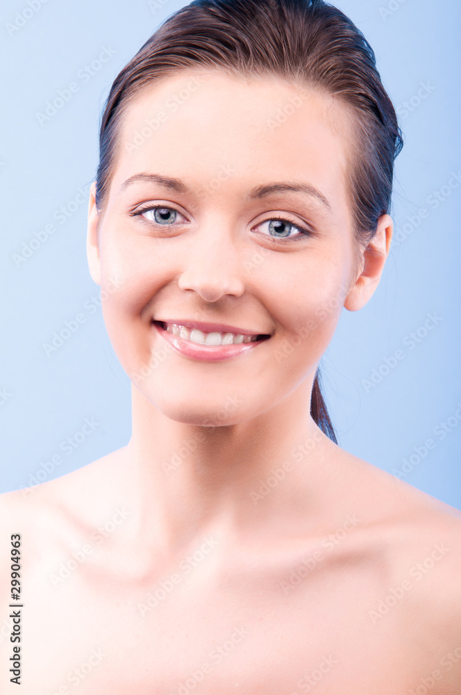 portrait of a beautiful happy woman looking at camera, on blue b portrait of a beautiful happy woman looking at camera, on blue b