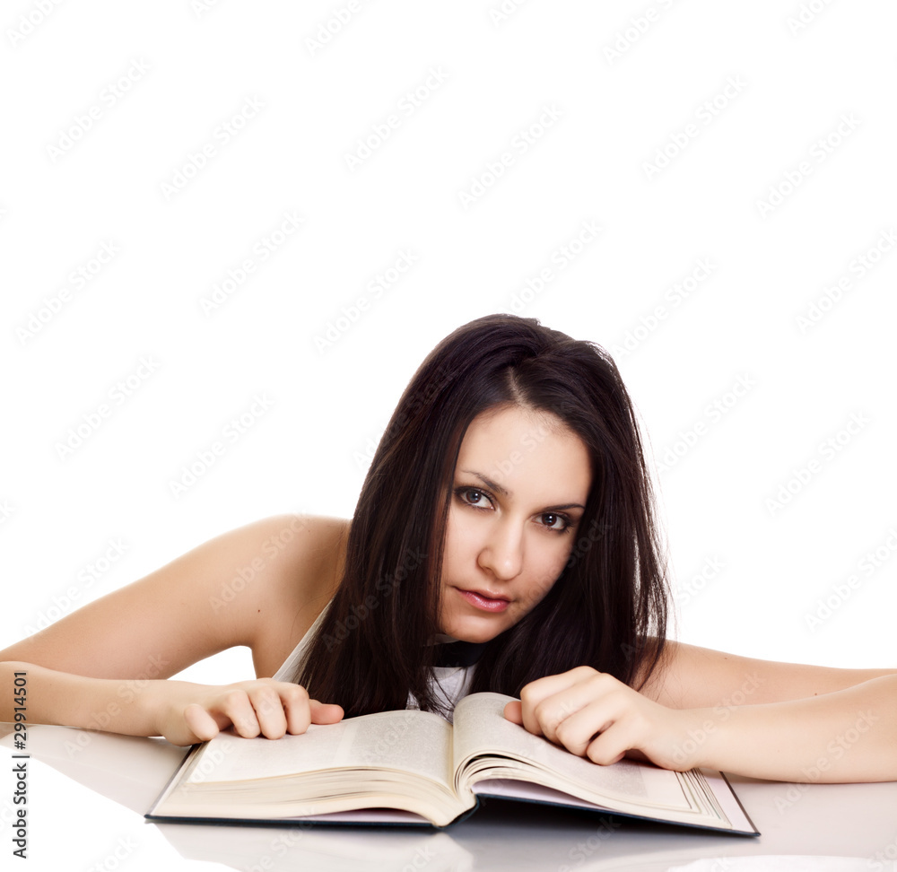 Friendly College student girl with books at the desk isolated Friendly College student girl with books at the desk isolated
