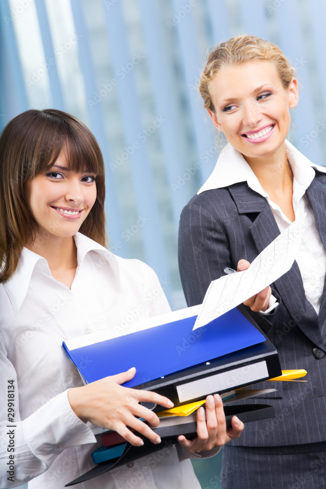 Two businesswomen working with documents at office Two businesswomen working with documents at office