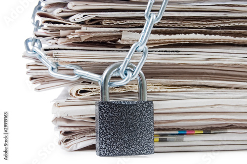 pile of newspapers with chains, on white photo