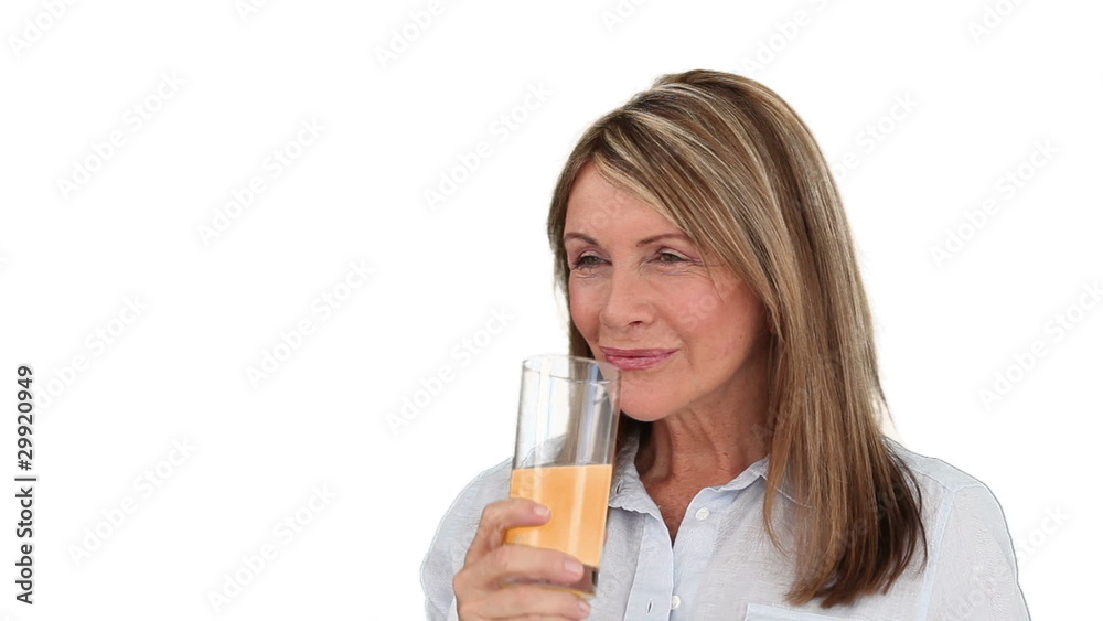 Mature woman drinking fruit juice Mature woman drinking fruit juice