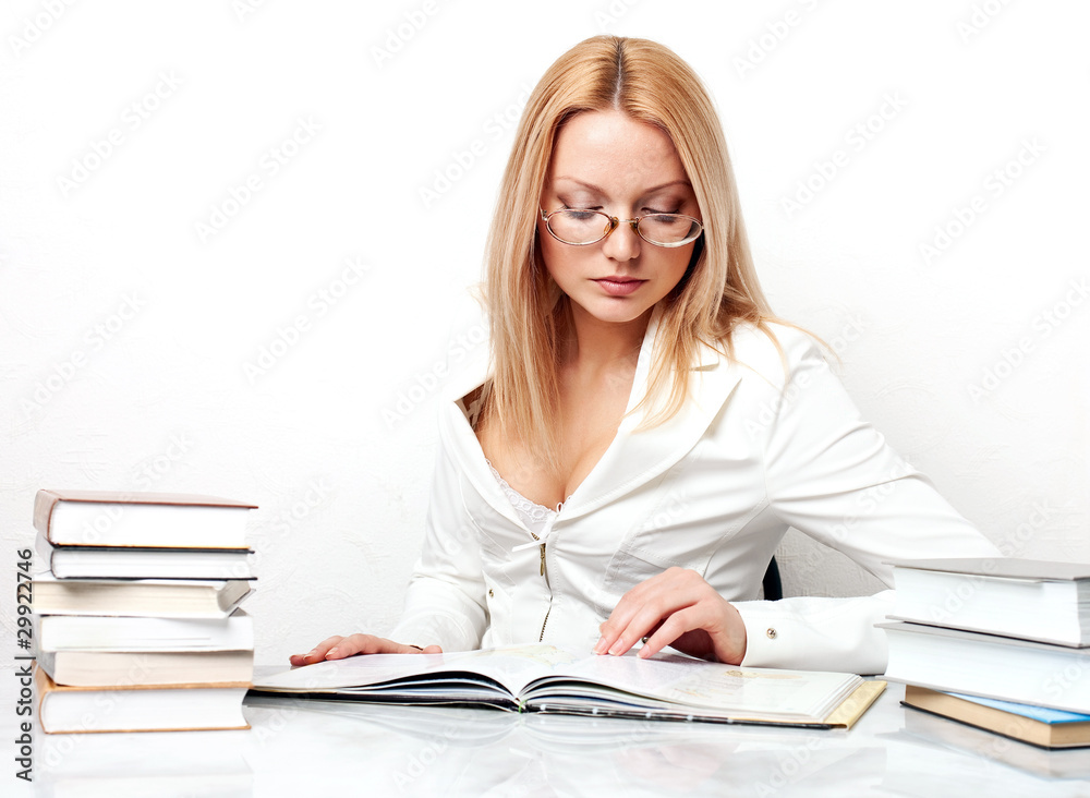 Young pretty woman learning at table with books Young pretty woman learning at table with books