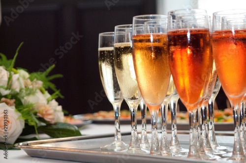 glasses of champaign on the tray with a bouquet photo