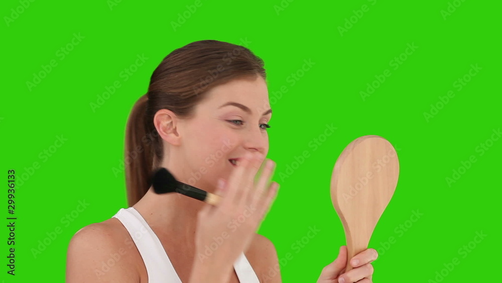 Brown-haired woman putting on make-up Brown-haired woman putting on make-up