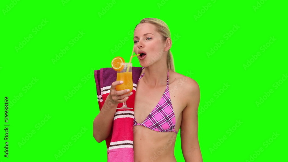 Woman in swimsuit sipping a cocktail Woman in swimsuit sipping a cocktail