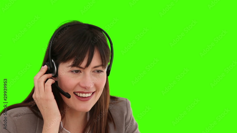 Friendly businesswoman speaking over the headset Friendly businesswoman speaking over the headset