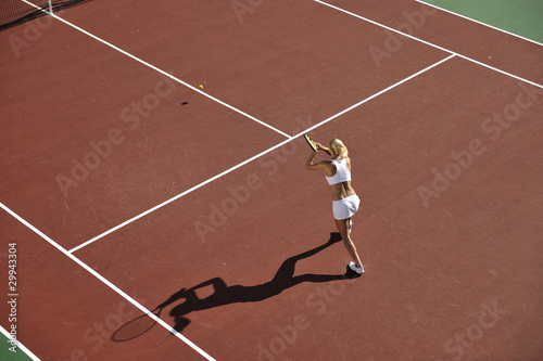 young woman play tennis outdoor © .shock