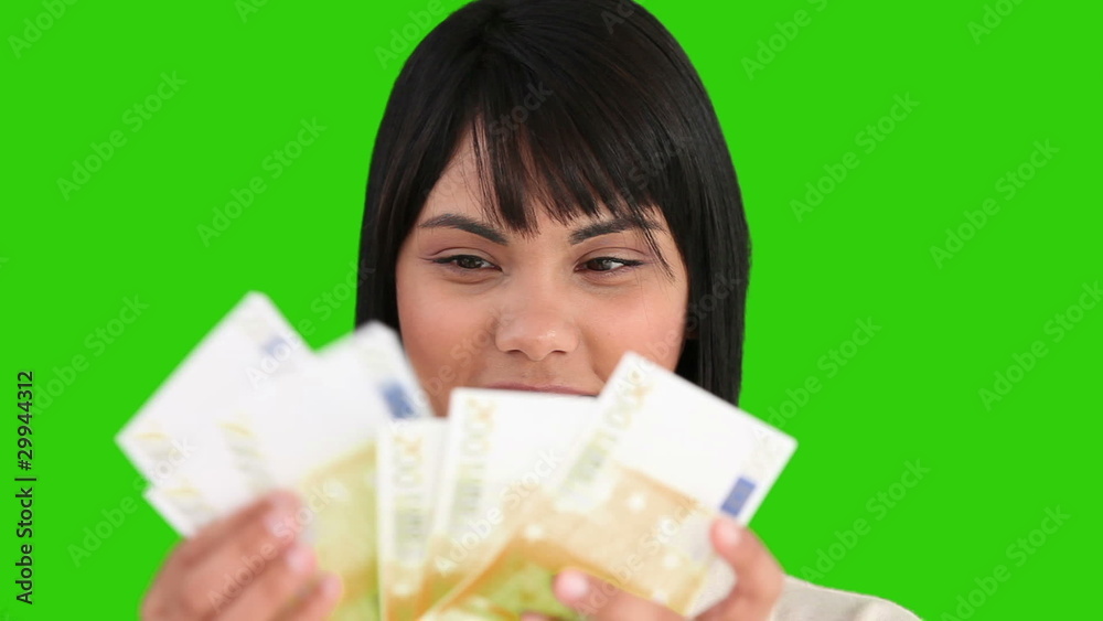 A young pretty asian woman counting her cash A young pretty asian woman counting her cash