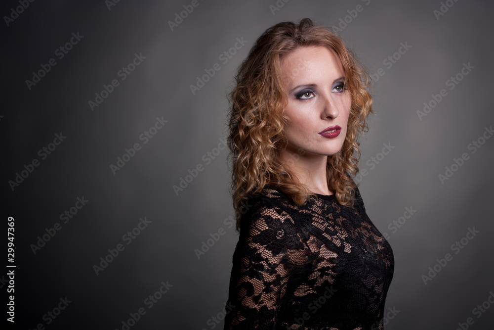 Young gorgeous model in a lace dress, a black background Young gorgeous model in a lace dress, a black background