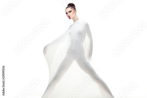 a conceptual studio shot of a young woman dressed in white. photo
