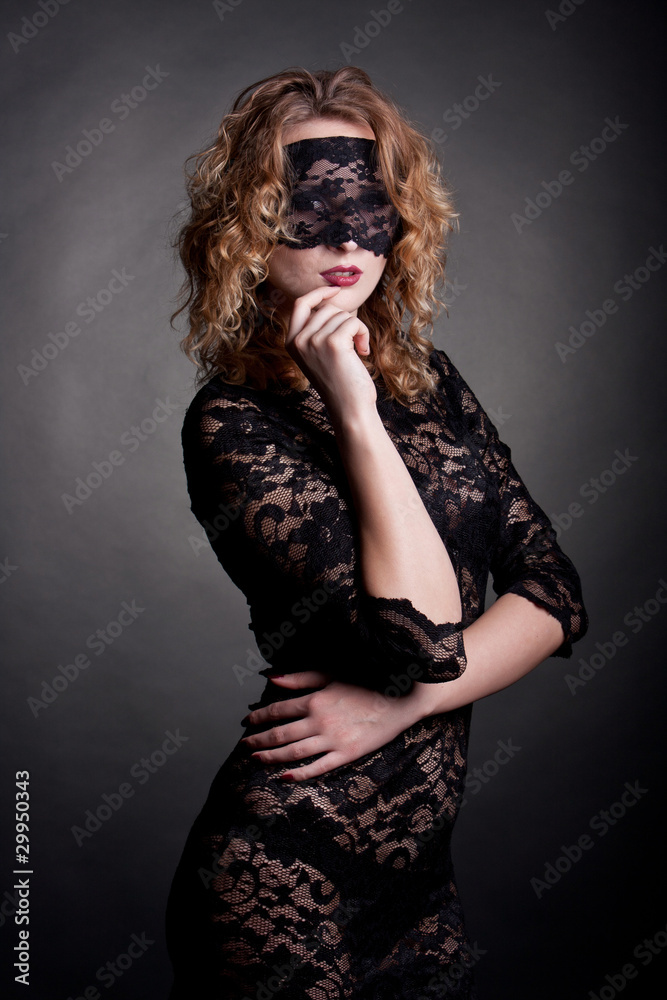 Naklejka premium beautiful woman with red lips and lace mask over her eyes