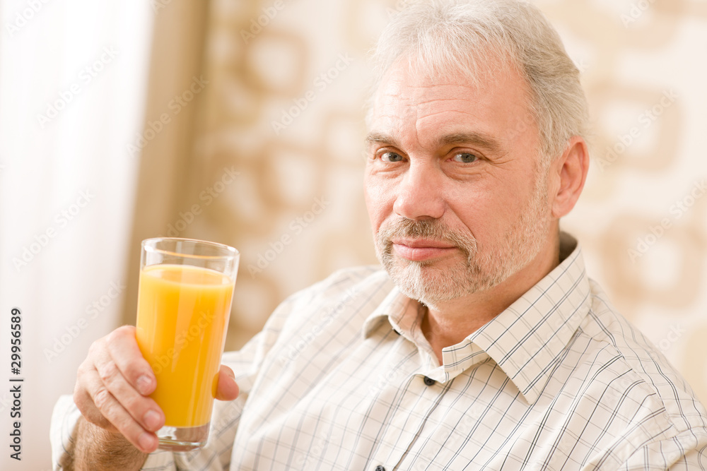 Senior mature man with glass of orange juice Senior mature man with glass of orange juice