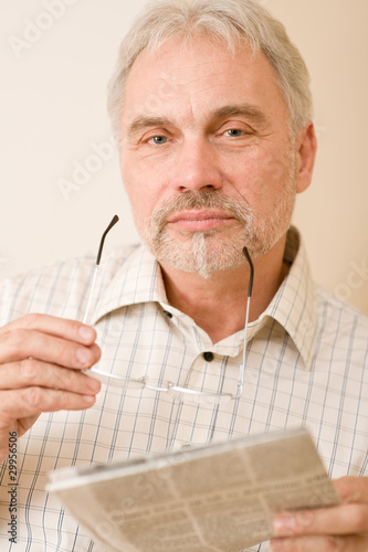 Senior mature man with glasses and newspaper