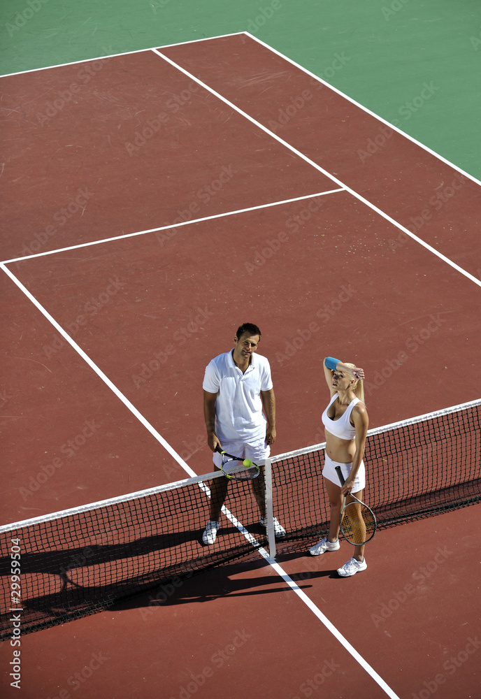 happy young couple play tennis game outdoor